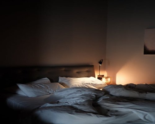 A calm, dimly lit bedroom ready for rest