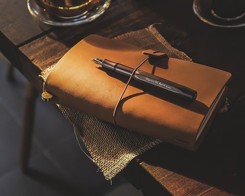 A notebook and pen on a desk